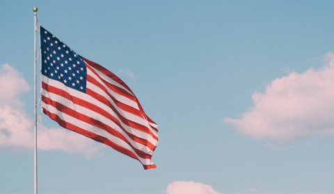 American flag flying against blue sky