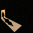 Clue figure in doorway cast in shadows.