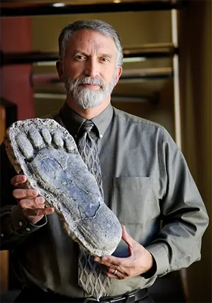 Portrait of Jeff Meldrum holding Sasquatch foot cast