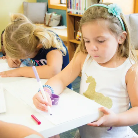 Child Writing at Storytime