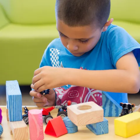 Kid Playing With Toys at the Library