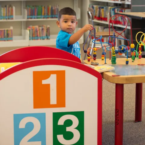 Toddler Playing with Activities at the Library