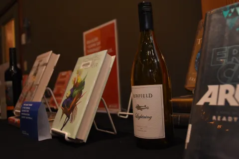 Books and wine displayed on table 