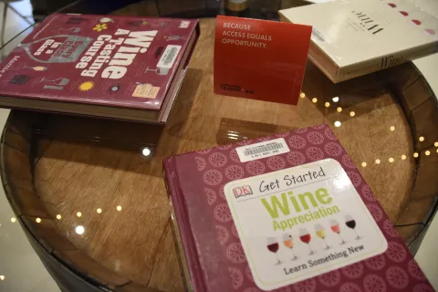 Books displayed on wine barrel